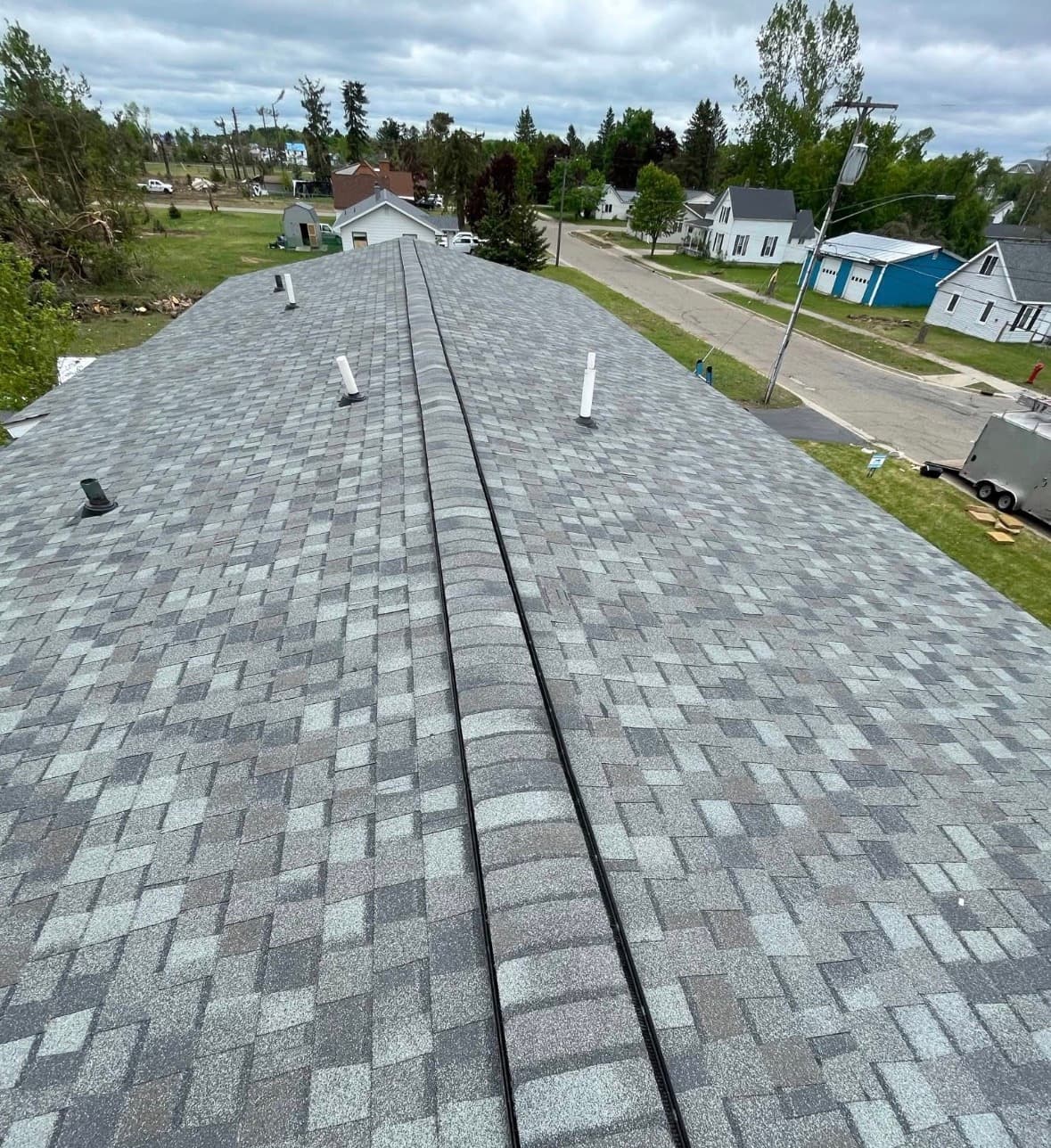 Finished gray architectural shingle roof on a West Michigan home
